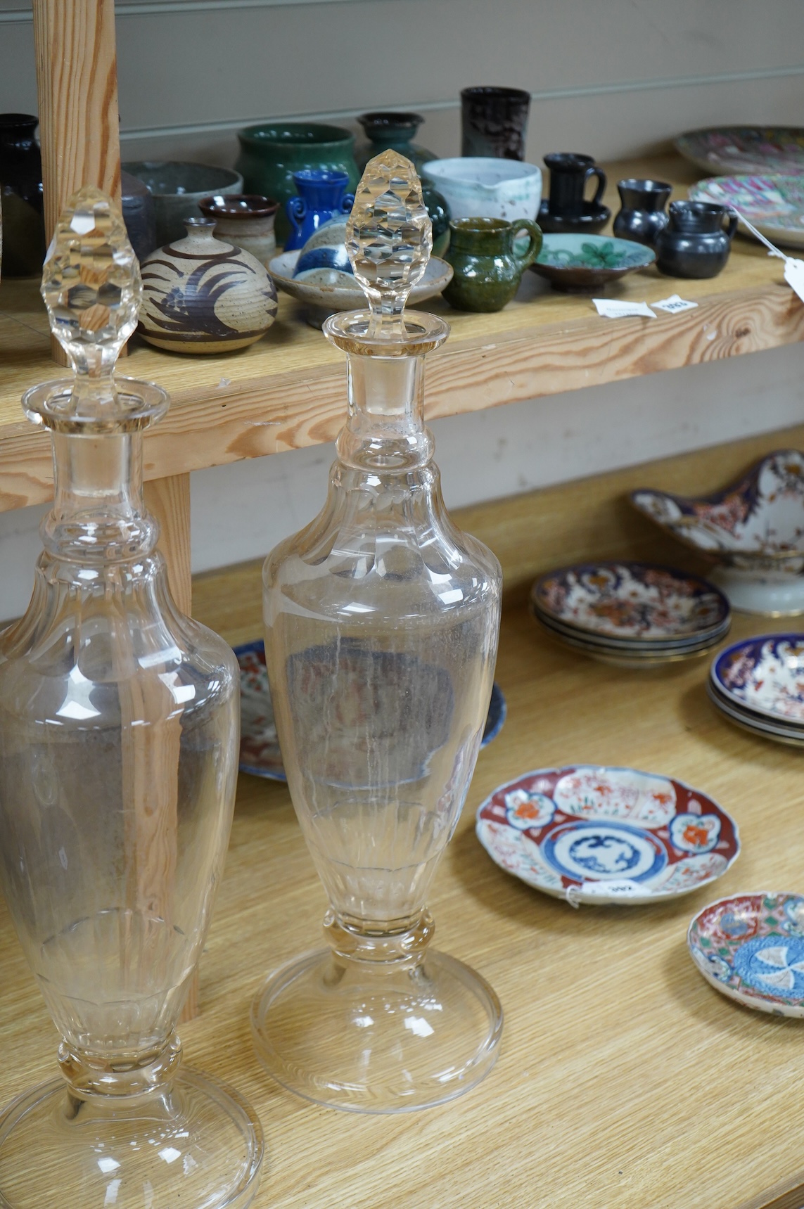 A pair of Victorian clear glass chemist display bottles and stoppers, 63cm high